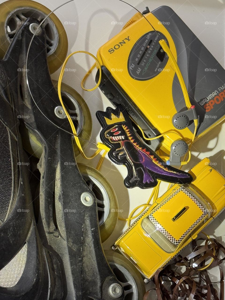 Roller blades, Sony Walkman, toy Checker taxi cab, cassette tape and Jean-Michel Basquiat keychain tag