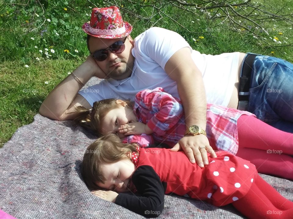 Father with his daughter lying on grass