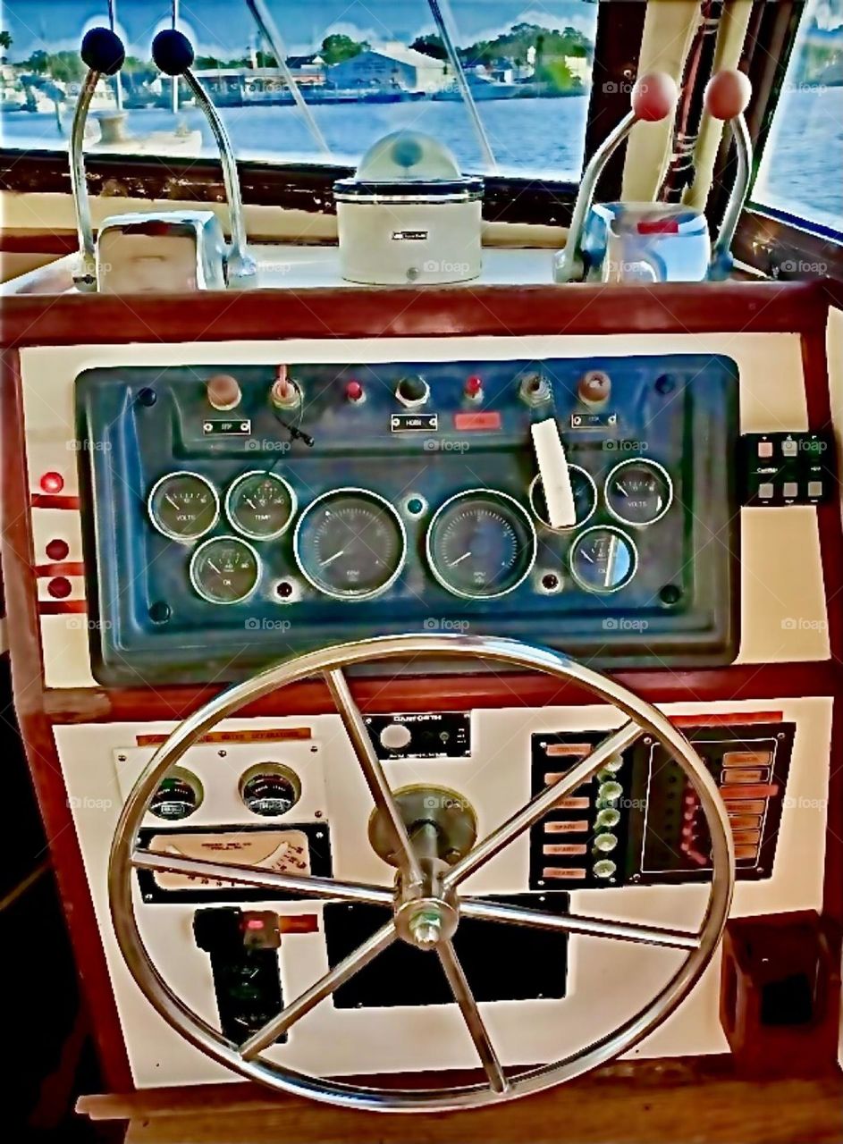The steering wheel and various control knobs on the dashboard of a large ship in the waters of the East River at Newtown Creek in Long Island City, Queens, NY we visited in late 2021. Hypnotic Productions
