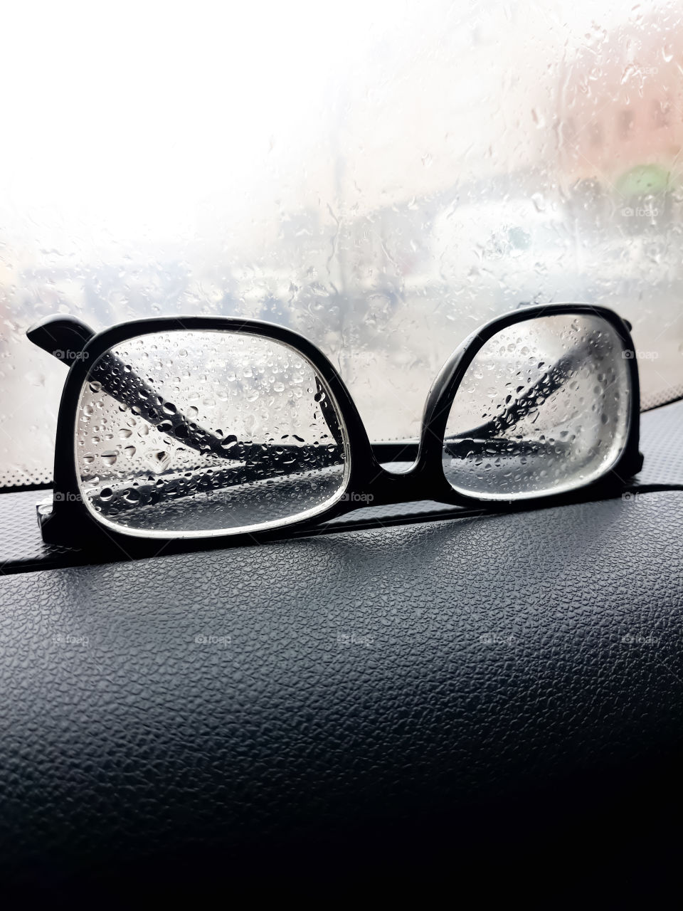 Eyeglasses placed near the car window.