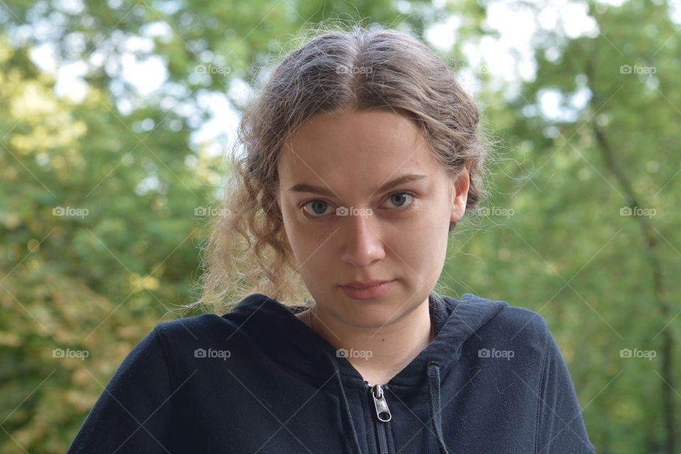 brunette girl beautiful portrait close outdoor green background