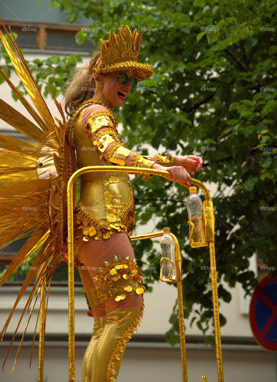 Unidentified dancerin heavy rain in Samba procession at the 26th Helsinki Samba Carnaval in Helsinki, Finland on Saturday June 18th, 2016 on Pohjoisesplanadi street. Different Samba schools compete against each other in parade around down town Helsinki.