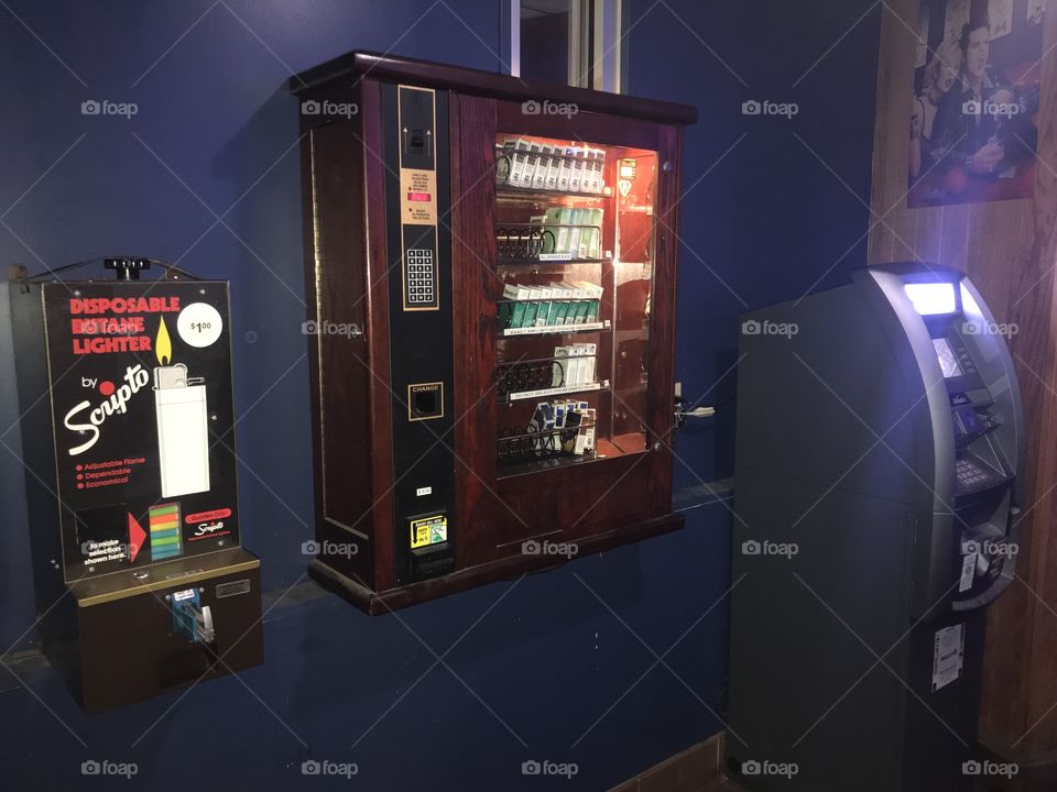 First you go to the ATM to get your cash, so you can go to the cigarette vending machine to get your smokes. If you have some change left over, you can buy yourself a lighter.  