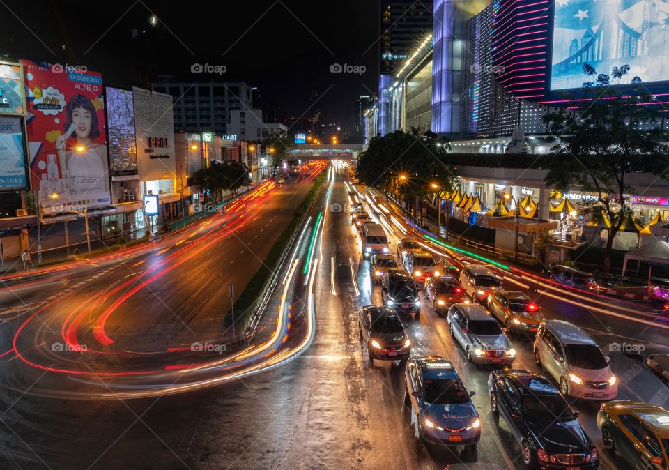 Beautiful Vehicle headlamp light at U turn road in front of the most famous shopping center MBK , Bangkok Thailand