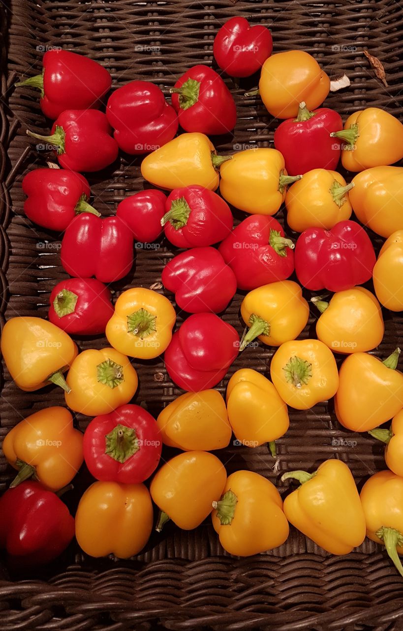 many red and yellow pepper in a basket