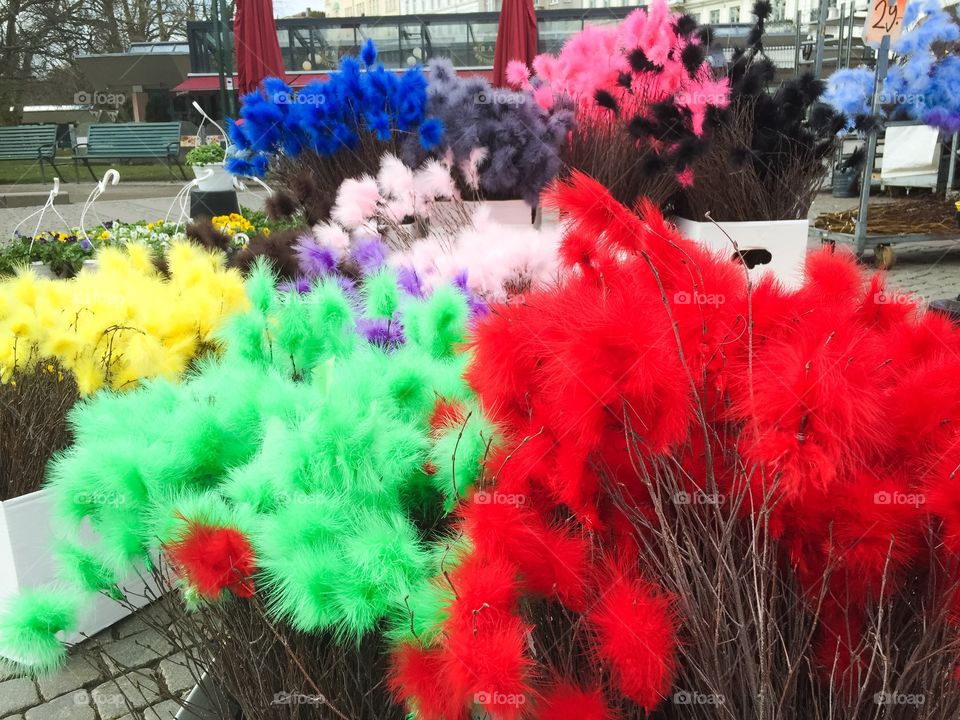 Easter feathers in different colors at a market in Malmö Sweden.