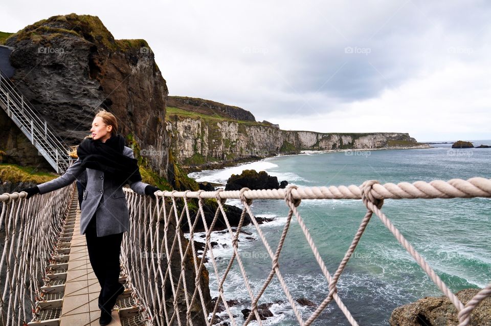 Young woman walking on bridge