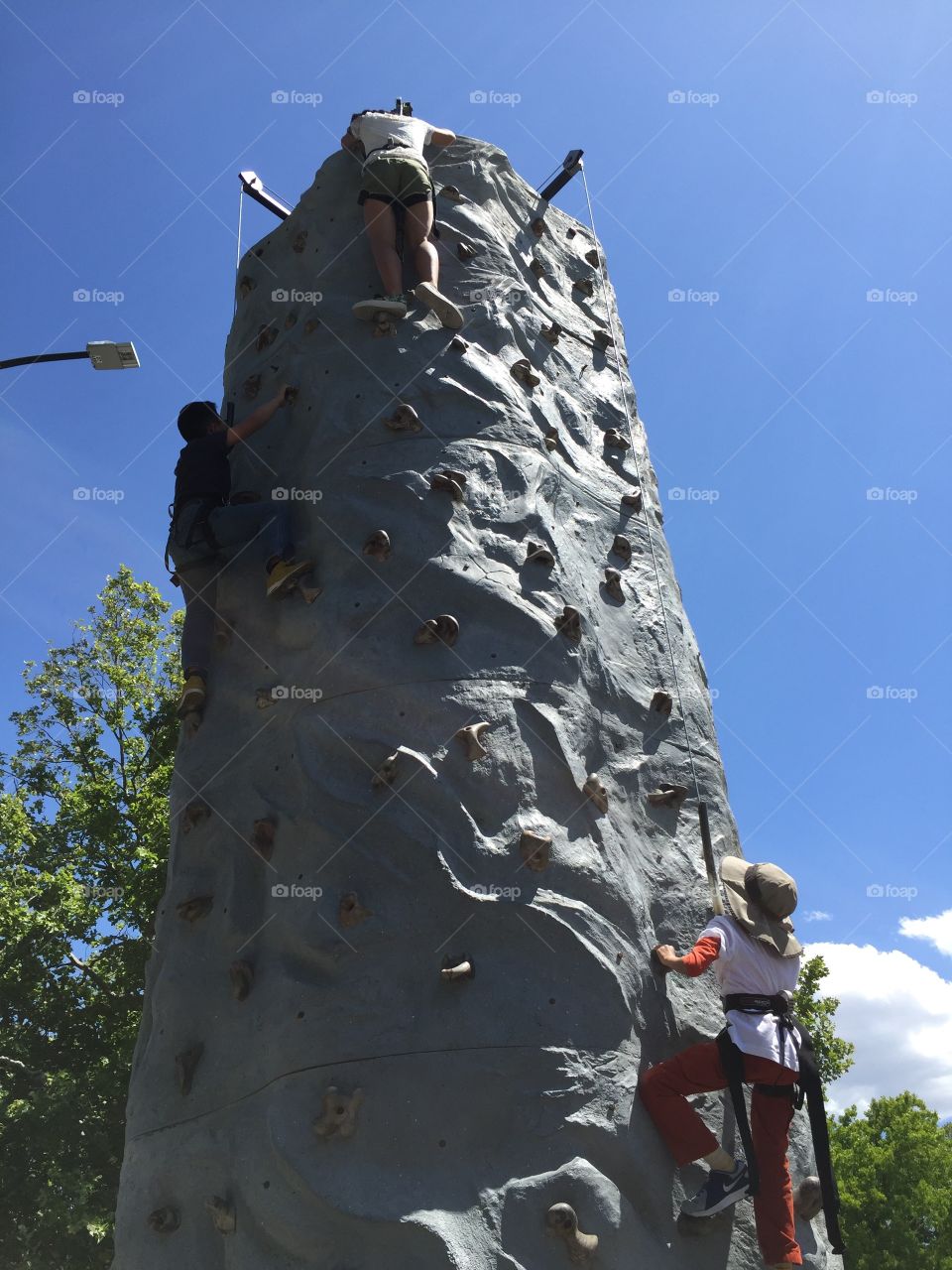 Kids climbing rock, rock wall