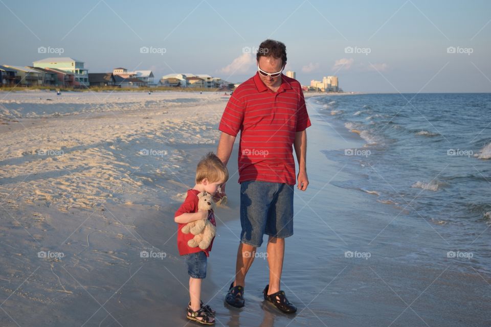 Father showing son the ocean