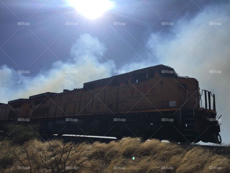 Train near Benson Arizona, with smoke from nearby wildfire burning about 3 miles away.