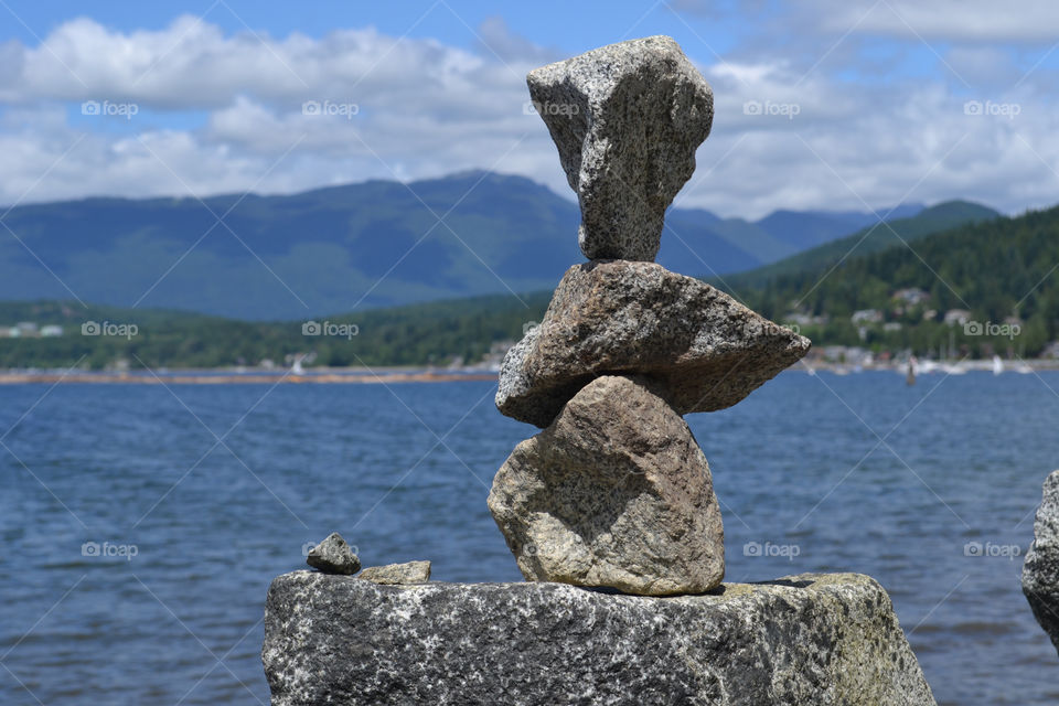 Stone stack overlooking ocean and mountains near Vancouver
