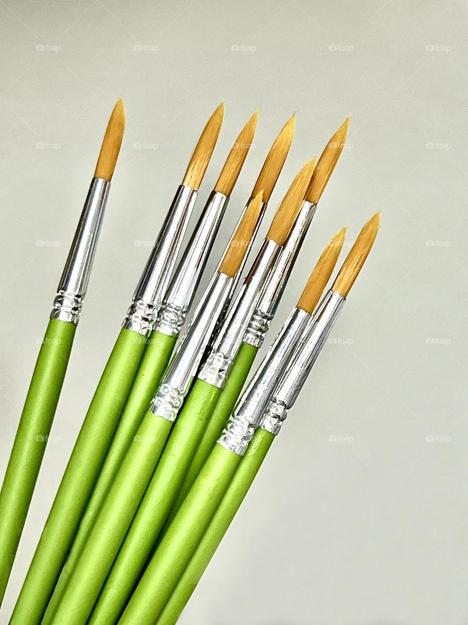Paint brushes with bright green handles.