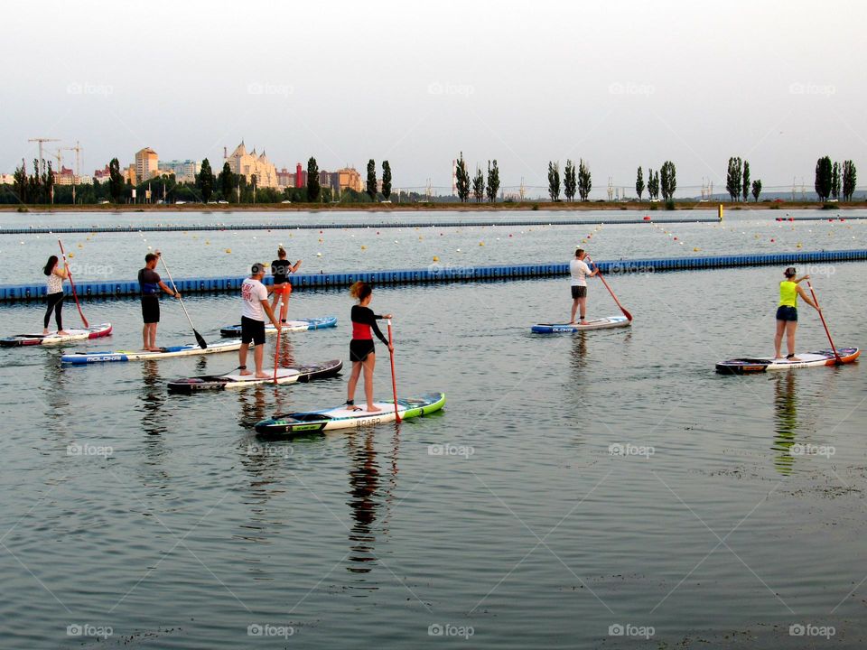 active recreation on the water, a girl with a paddle, the city of Voronezh in Russia