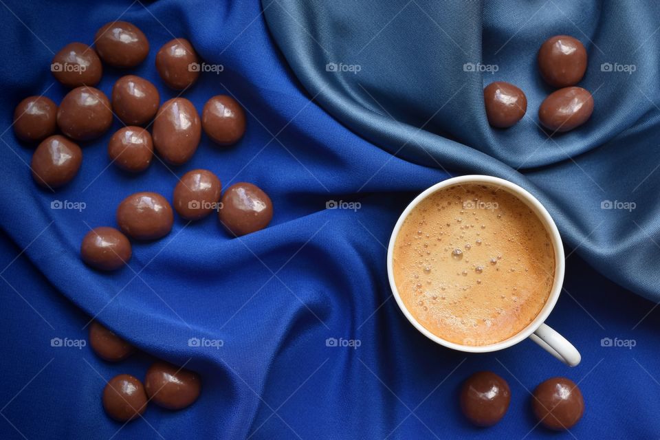 Coffee and chocolate on a blue background 