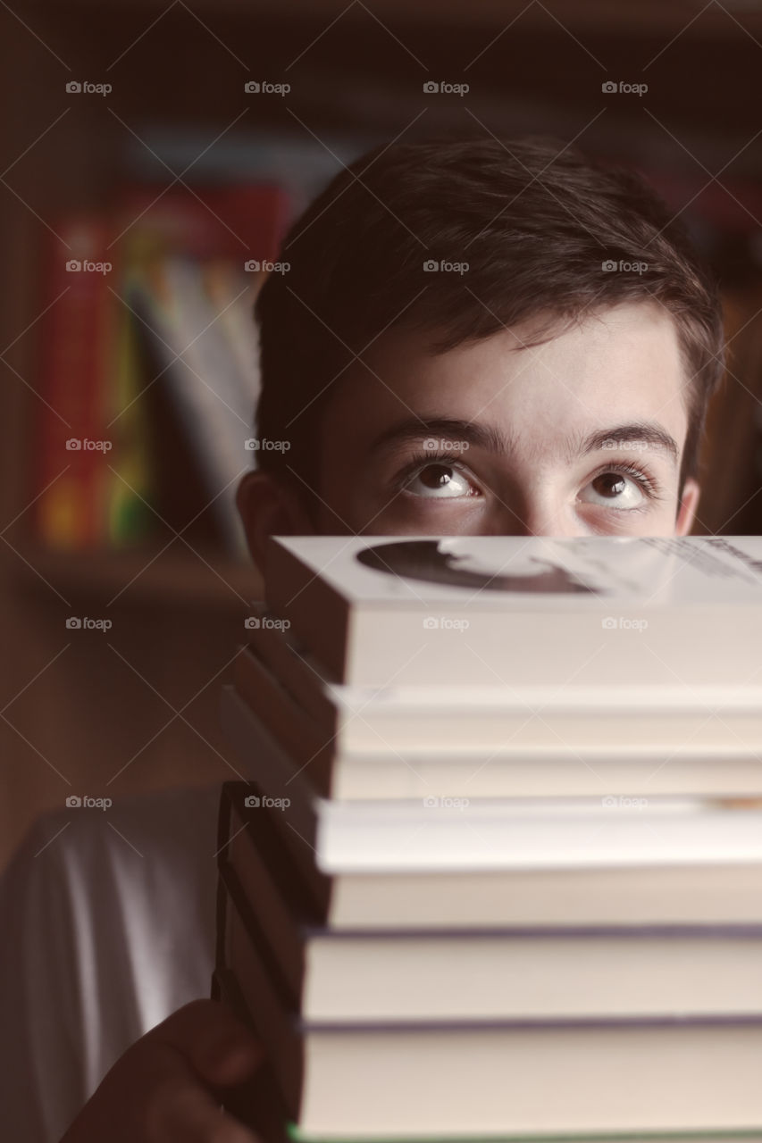 Time to back to school - child with stack of books.