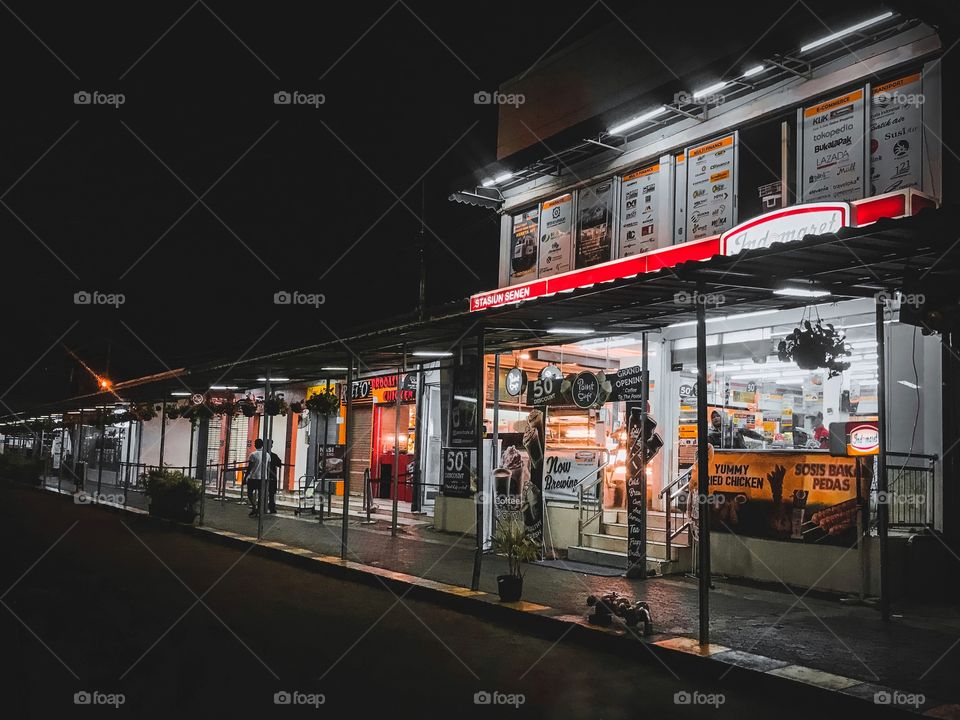 Lines of stores with interesting light at night.