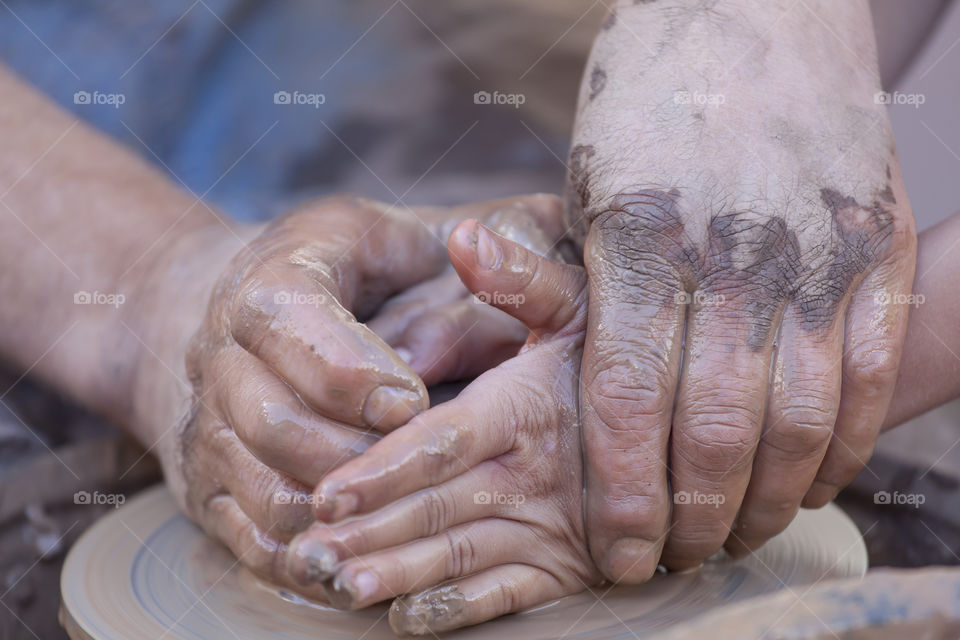 Close-up of hand making pottery
