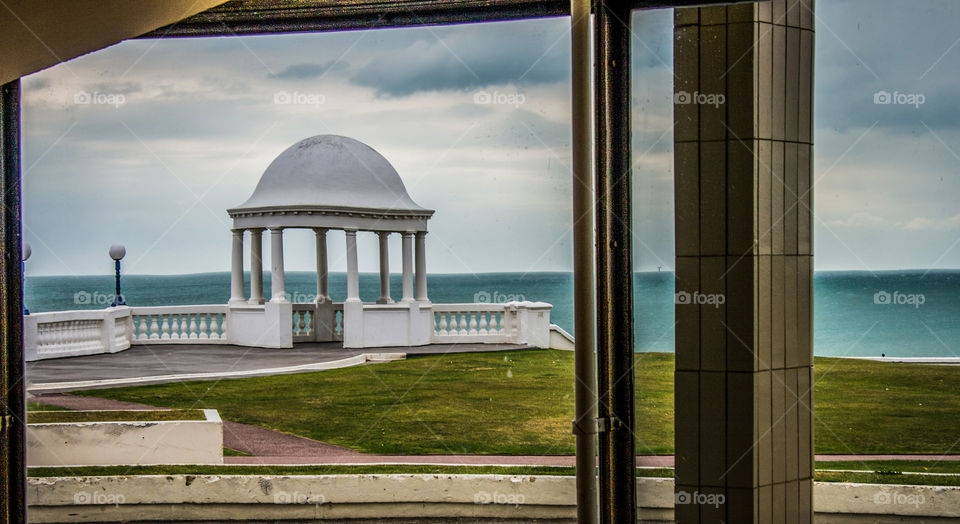 The curved glass of this building creates a slight distortion on the pavilion and sea horizon viewed on the outside