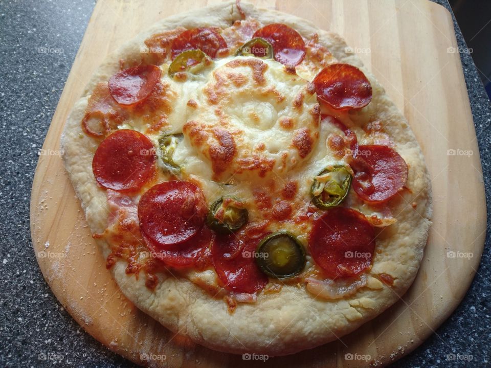 delicious homemade pizza, olive oil, oregano, garlic, mozzarella, bacon, pepperoni and pineapple
