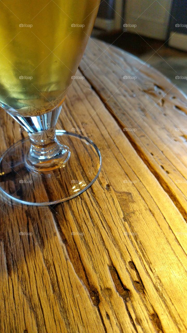 Glass of beer on an old wooden table