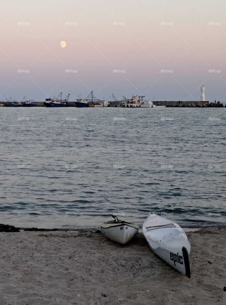 Canoes at full moon on the beach