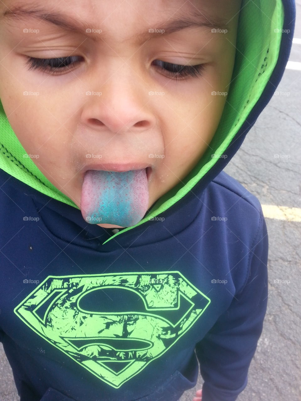 Boy sticking out blue tongue