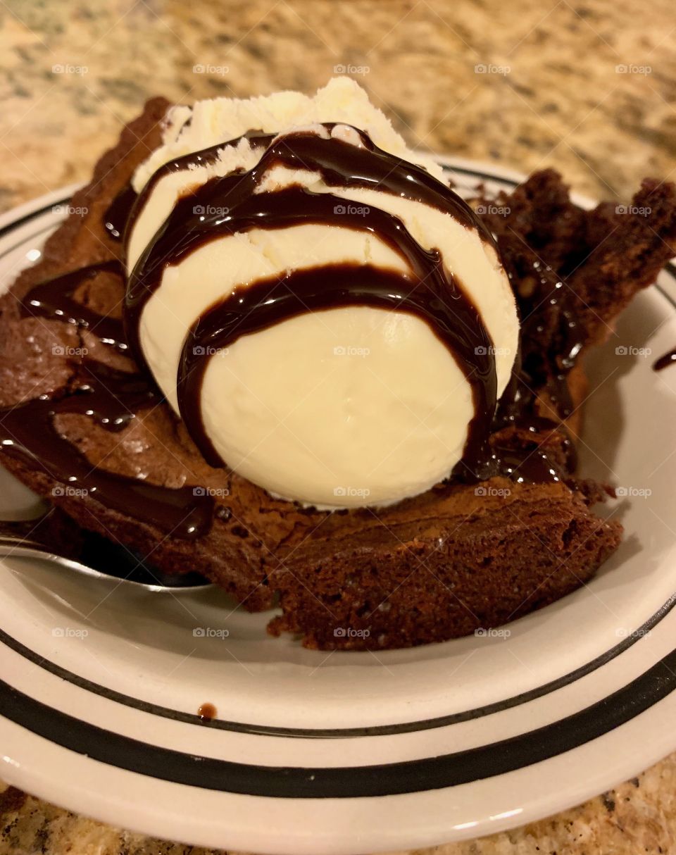 Dessert Chocolate Brownie with Vanilla Ice Cream Drizzled With Chocolate Syrup 