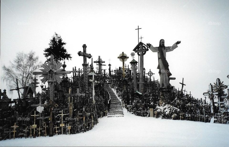 Snow on hill of crosses 