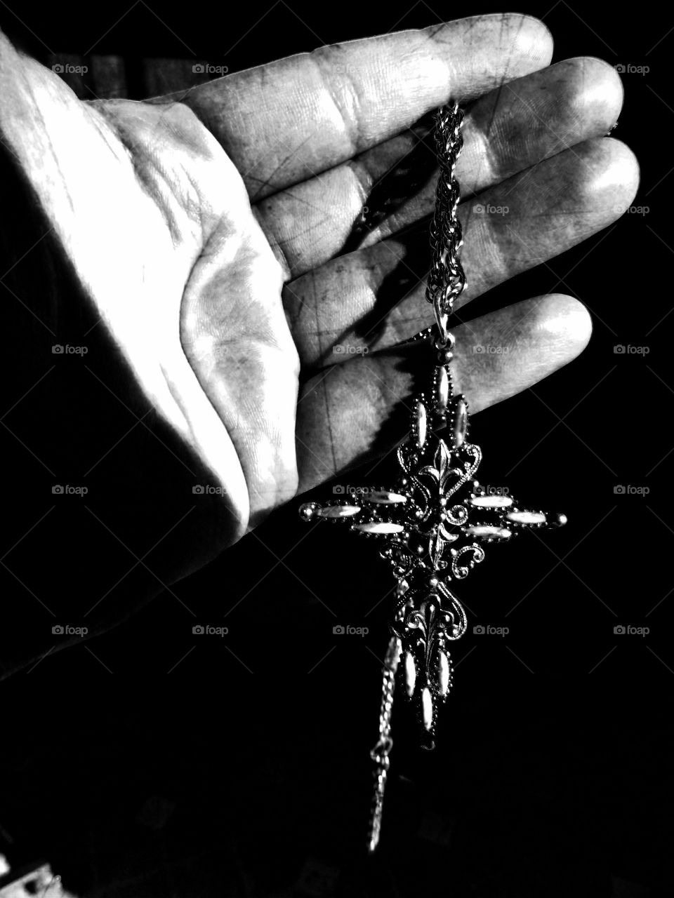 Hand and cross black and white 