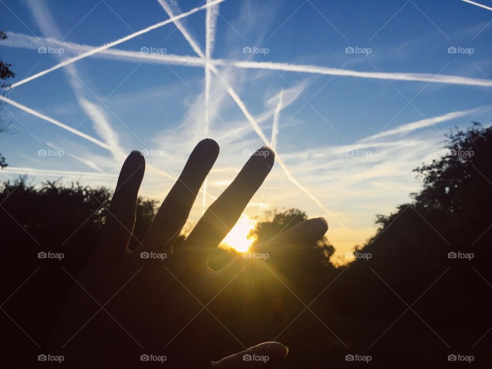 while I was walking in the meadow in the afternoon, I looked up and see the beautiful sky, with white streaks running through each other , I raised my hand to block the light a little bit and took a picture. You see, the sun is beautiful