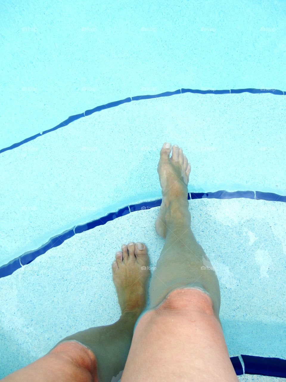 Low section of person's leg in swimming pool