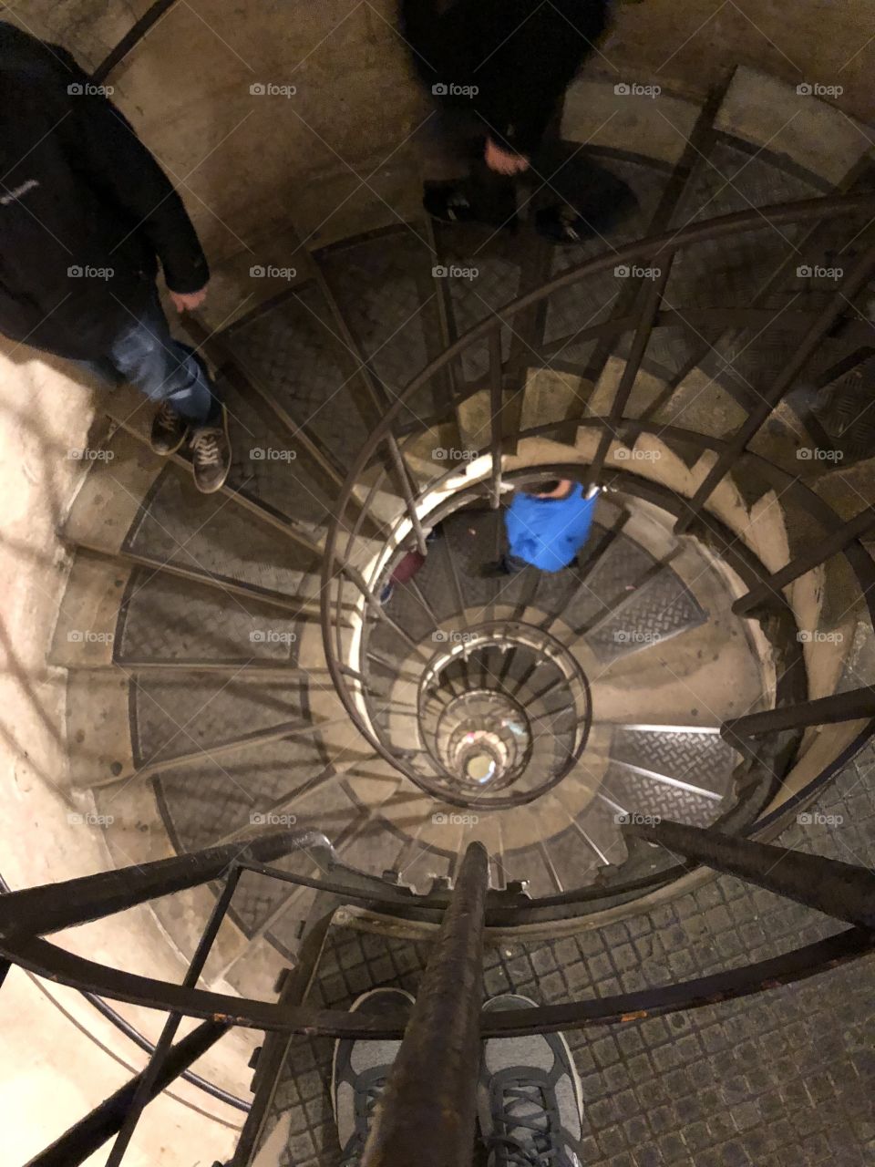 A long, winding staircase taken from the top of the Arc de Triumph in Paris, France. 