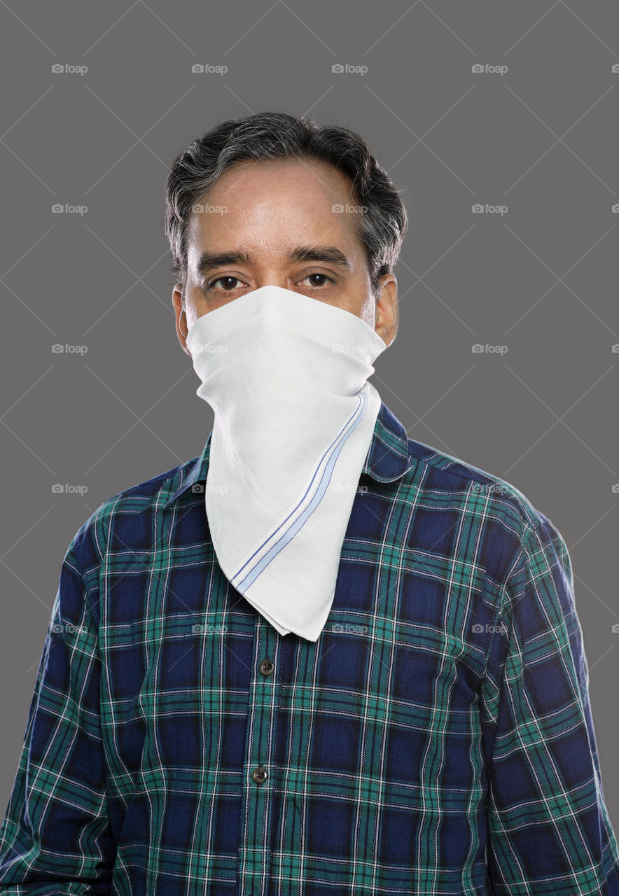 Indian man with Handkerchief as mask for protection against Coronavirus