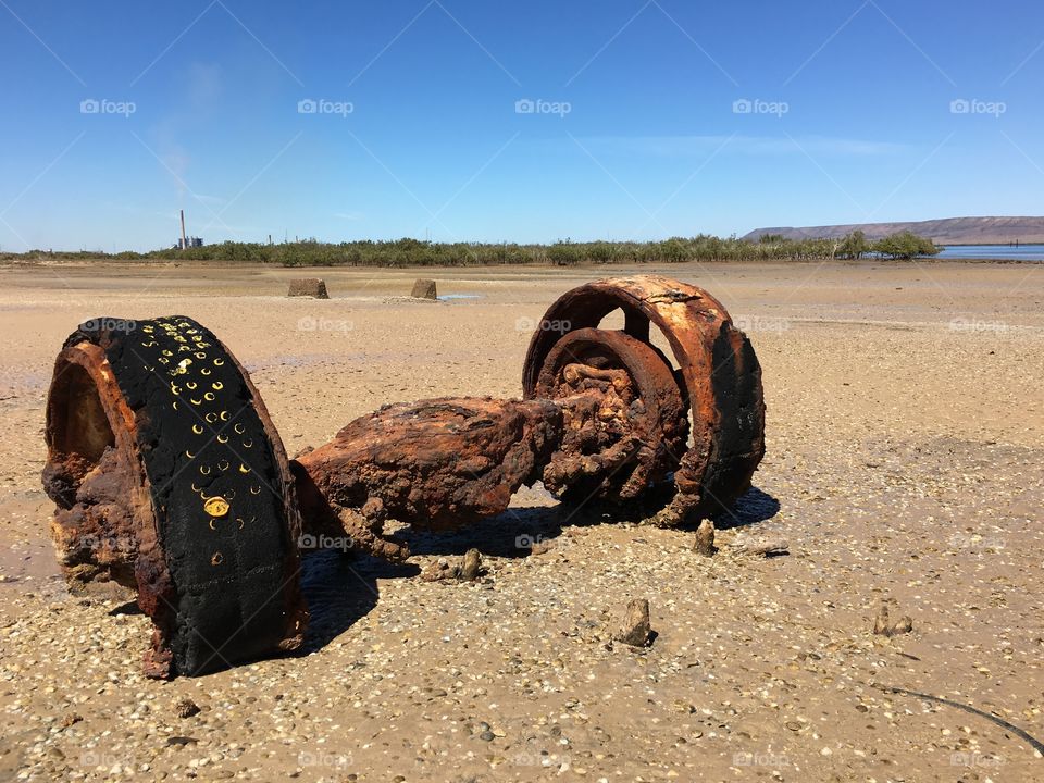 Beach debris at low tide in Port Augusta, South Australia; rusted iron machinery