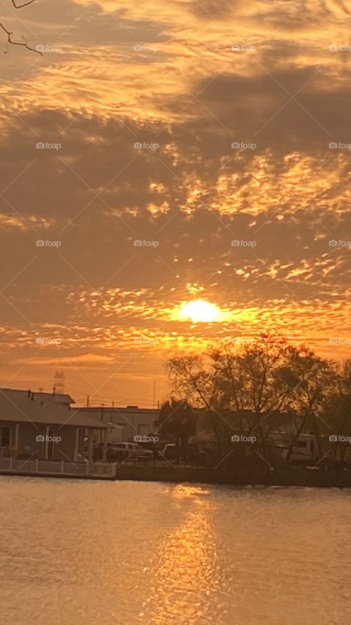 Early evening sunset with 2 separate Reflections on Lake Waters.  Evening colors present but lots of clouds also present. So so for good sunset pics. 
