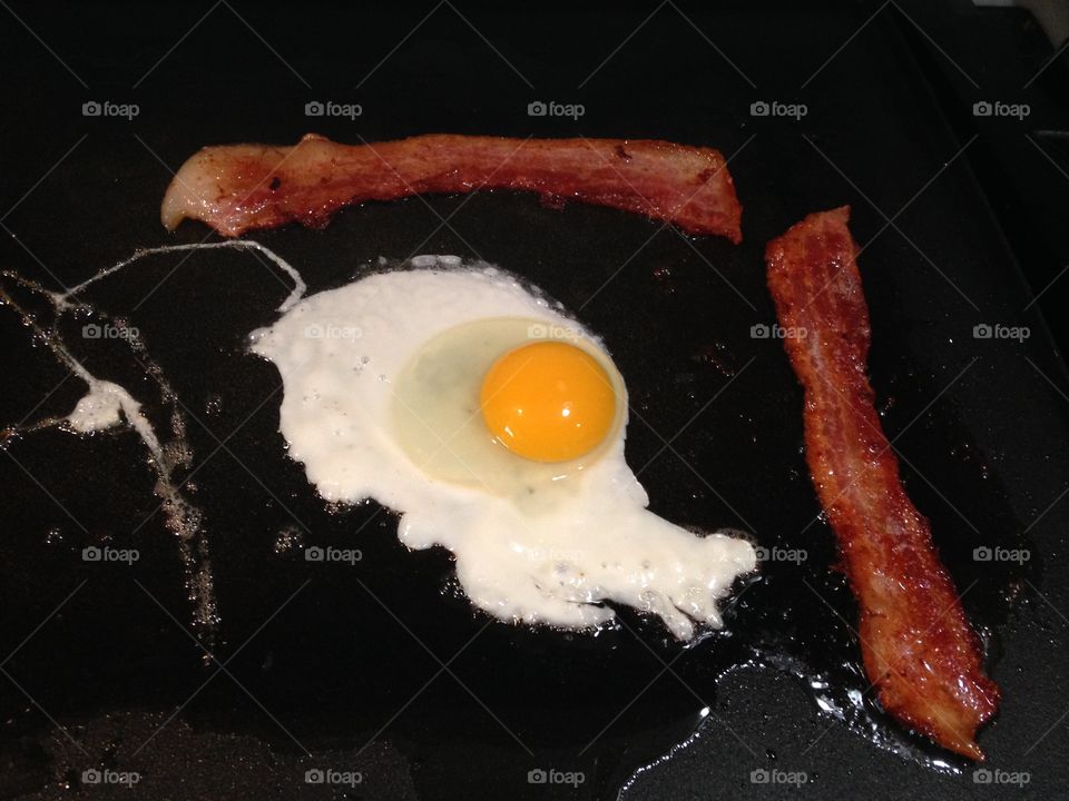 Bacon and eggs. Bacon and egg cooking