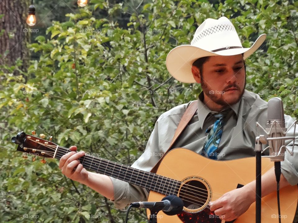 Country Music Guitar Player. American Cowboy Playing Country Music
