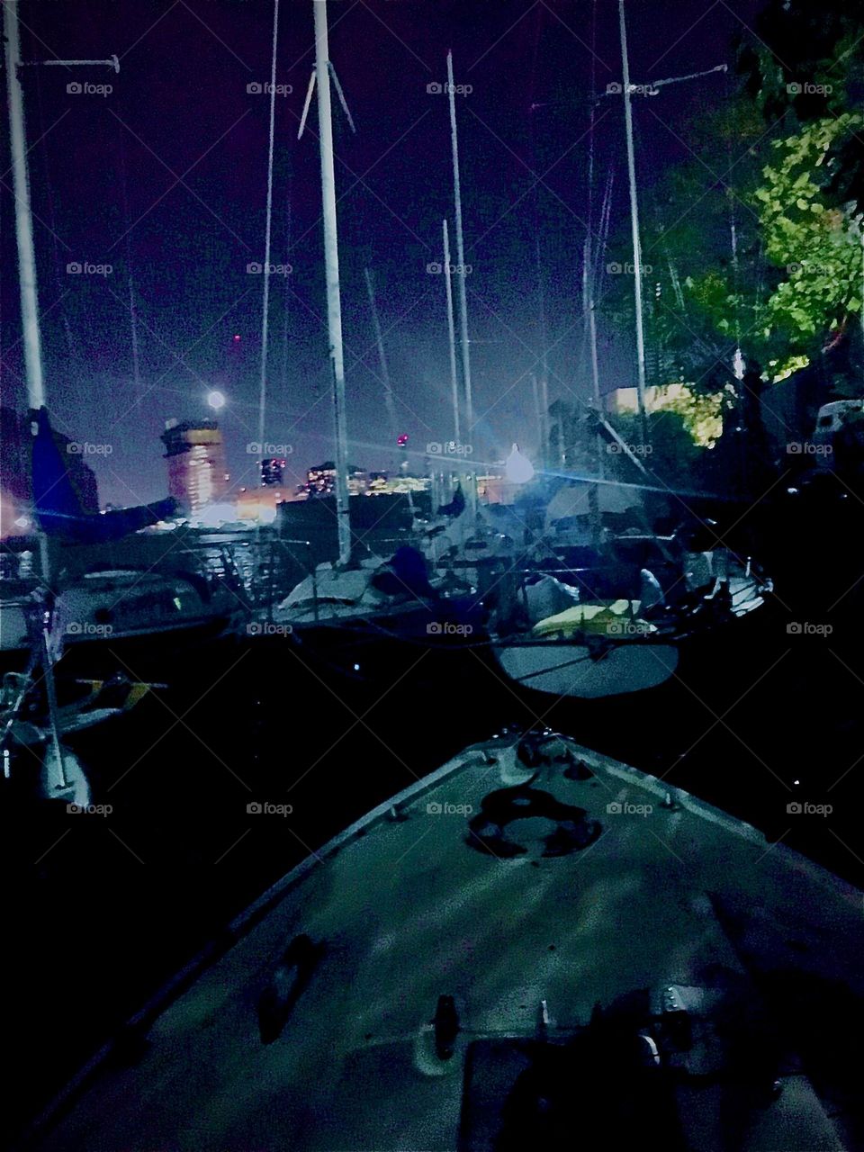 This is what “Newtown Creek” by the “Pulaski Bridge” looks like at night with its many boats and a view of some brownstone buildings across the “East River” in “Greenpoint”, Bklyn. 2022. Hypnotic Productions