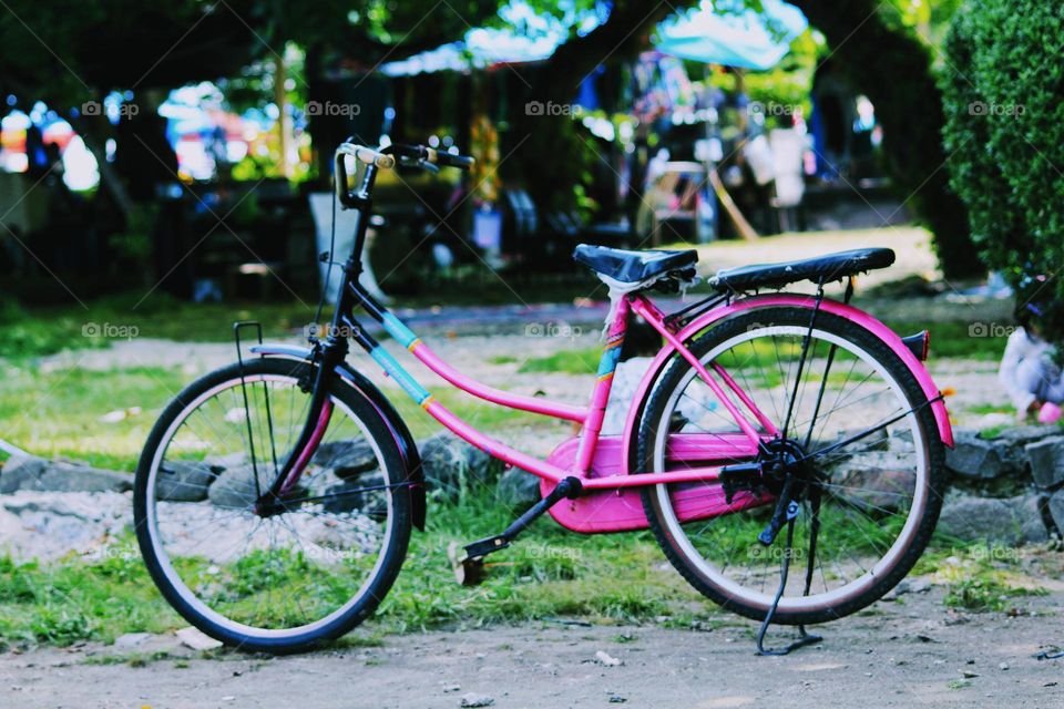 The bicycle is pink.