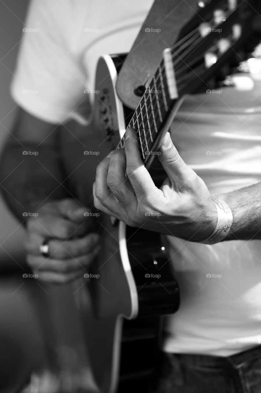 Close up of a man playing guitar