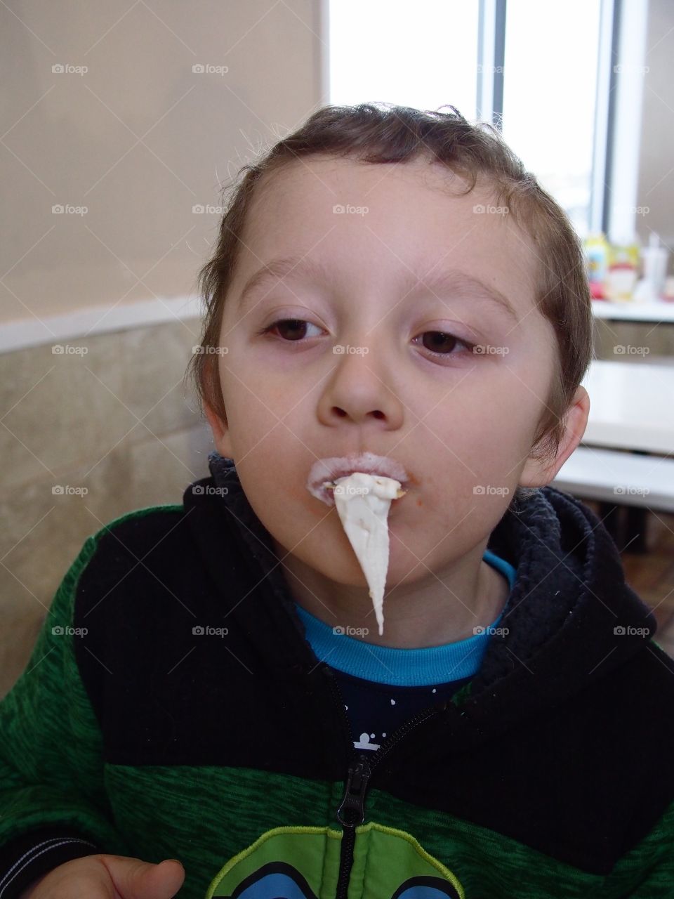 A little boy hilariously loses control of his vanilla ice cream as a giant bunch leaves the cone unexpectedly. 