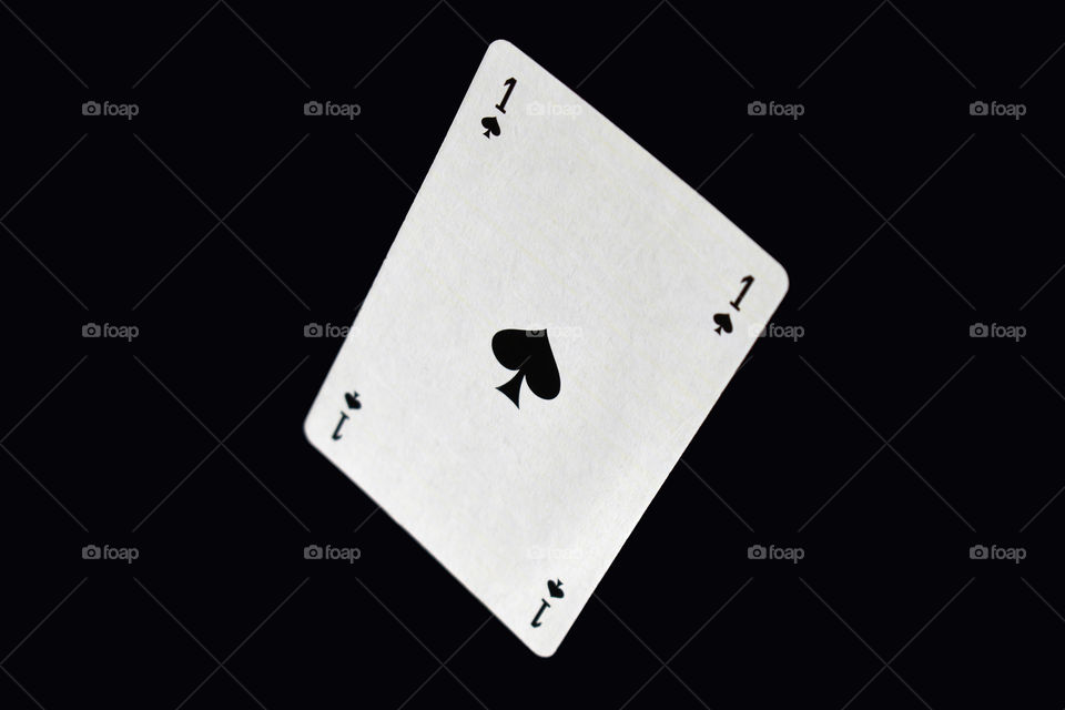 ace of spade on black background