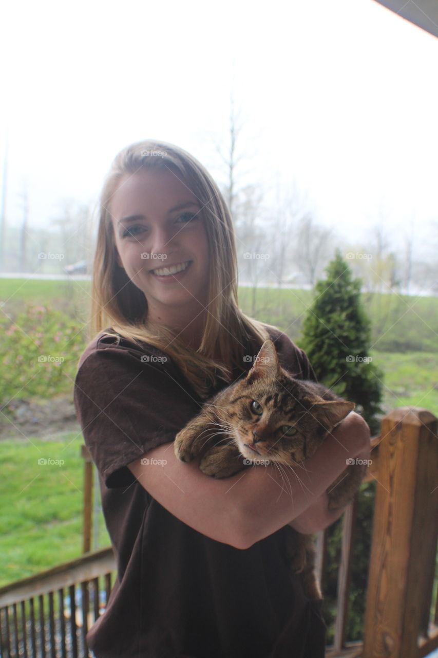 Blonde girl holding soft fuzzy cat