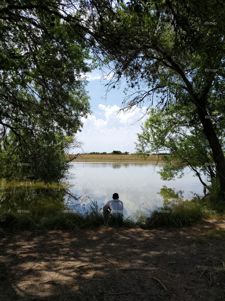 Stillness within - a meditative moment for a man by a lake.