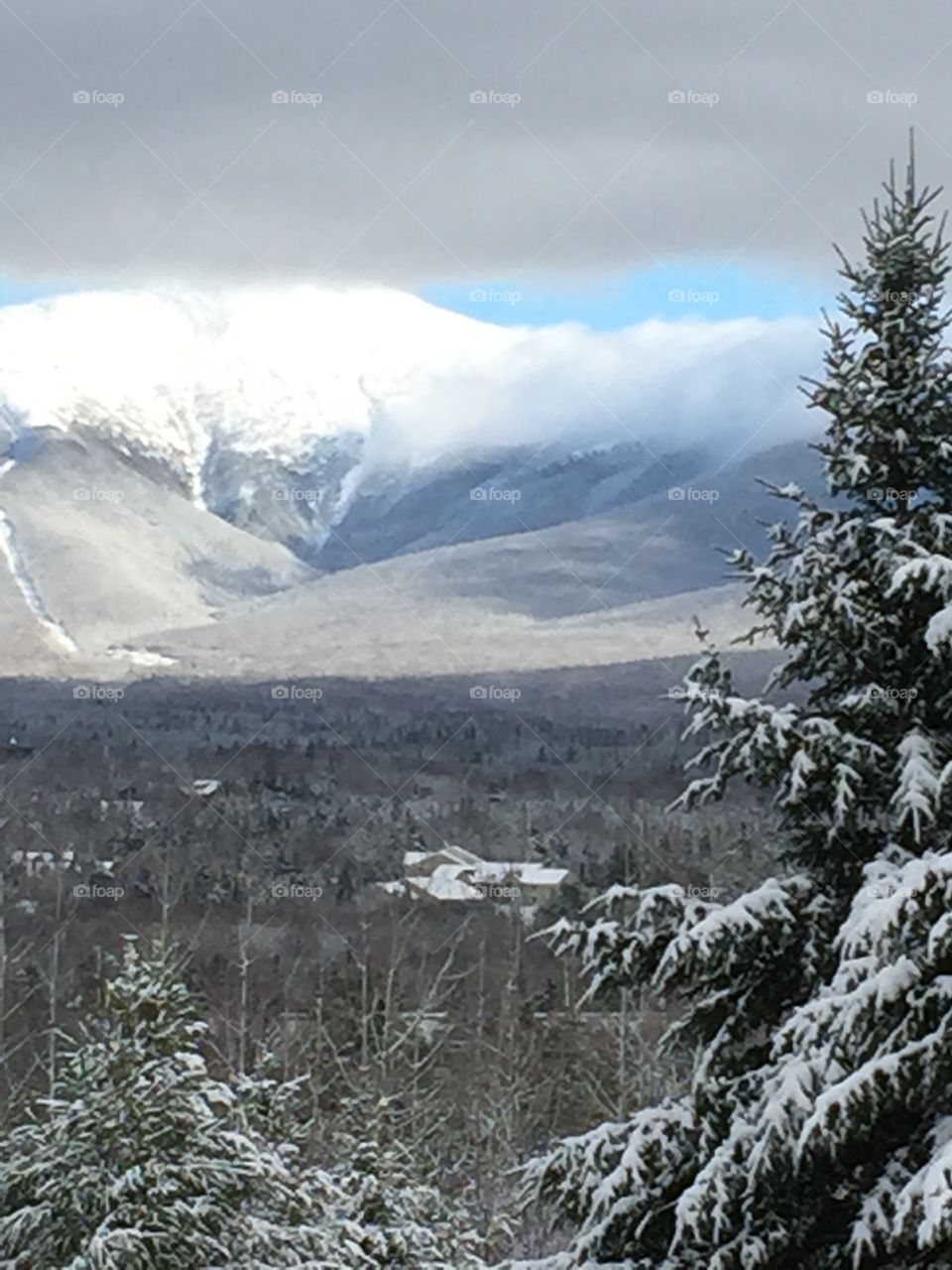 Majestic views of the snow capped mountains and stunning sky in The white mountains of New Hampshire. 