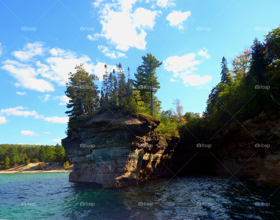 Breathtaking scenery with water, a cliff and trees