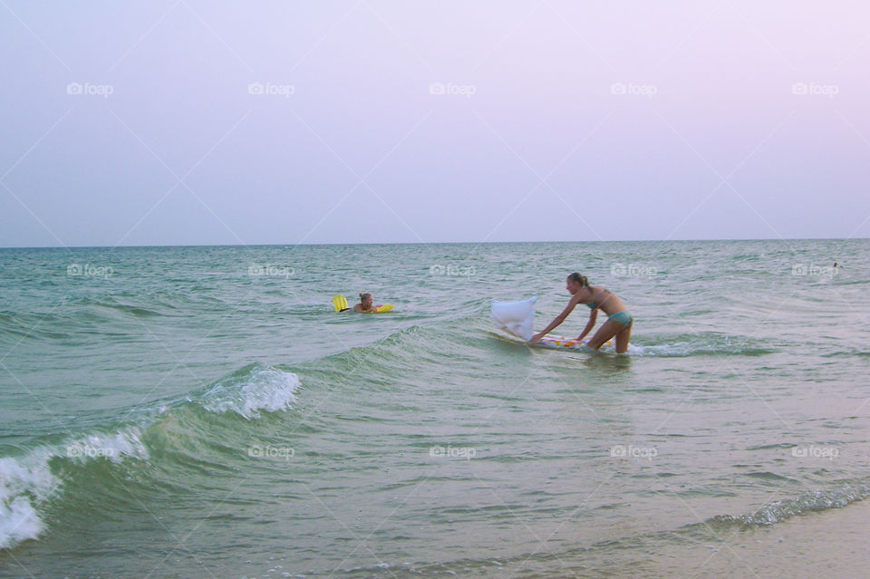 Girls bathe in the sea