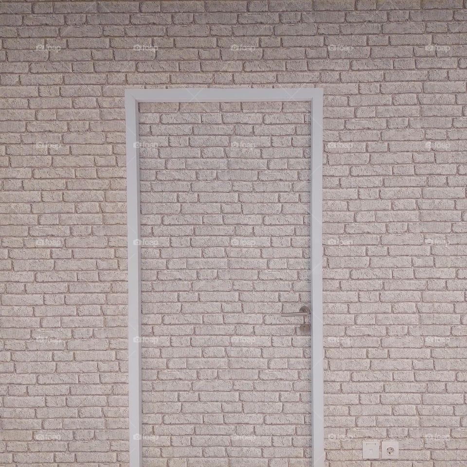 brick wall motif with a unique door design