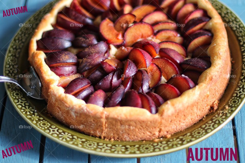 Homemade fresh plum cake on a green plate 