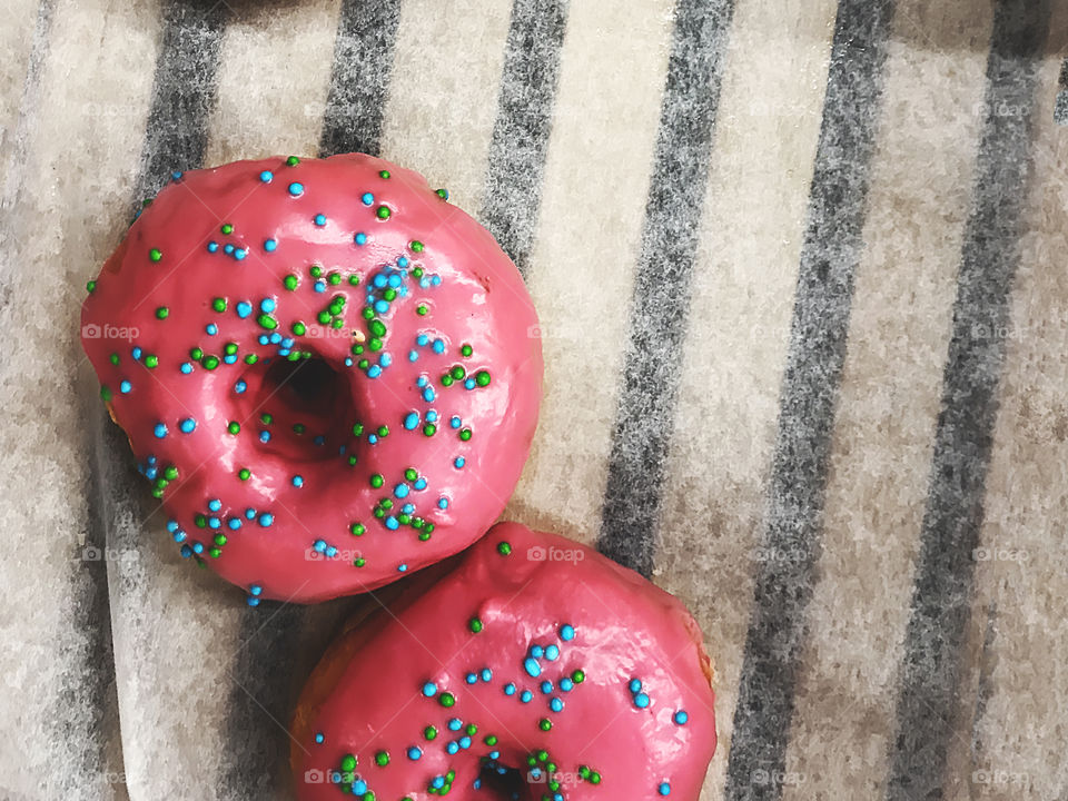 Pink donuts with colorful sprinkles 